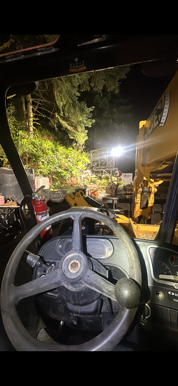 Night drilling yard from operator cab with lights and heavy equipment
